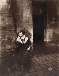 La Villette. Rue Asselin, prostitute waiting in front of her door